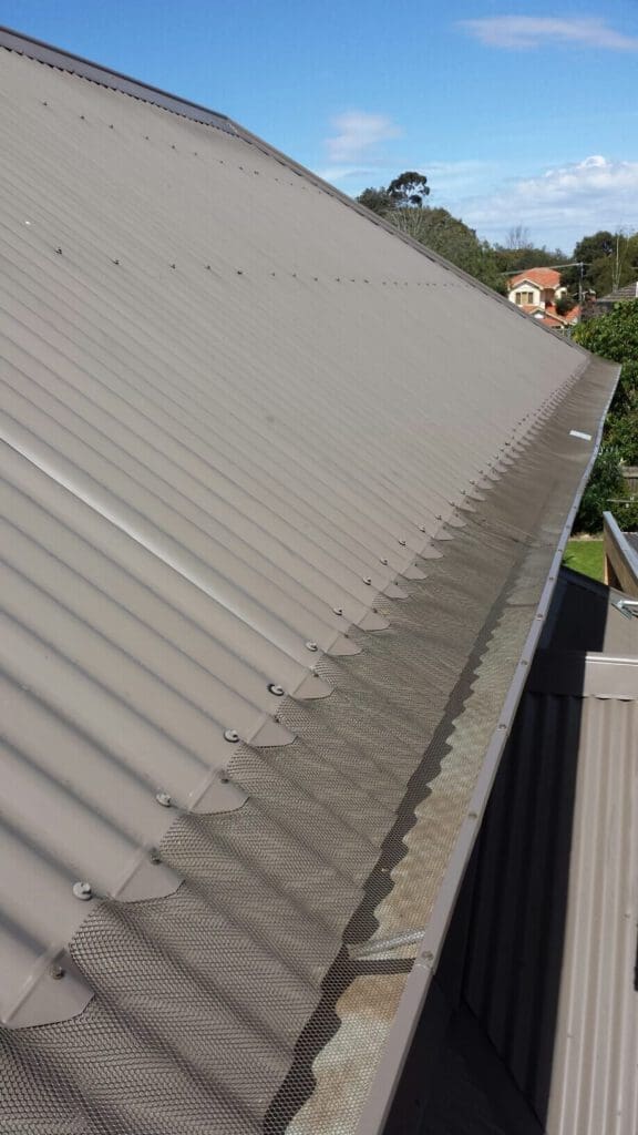 View of gutter guard mesh installed in a roof gutter